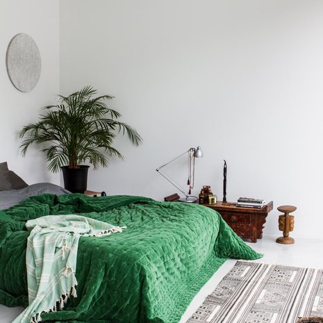 Makuuhuoneeseen valittiin vihreän Mokon päiväpeiton tuomaan energiaa. Seinässä sängyn päällä on turpeesta valmistettuja akustiikkalevyjä.